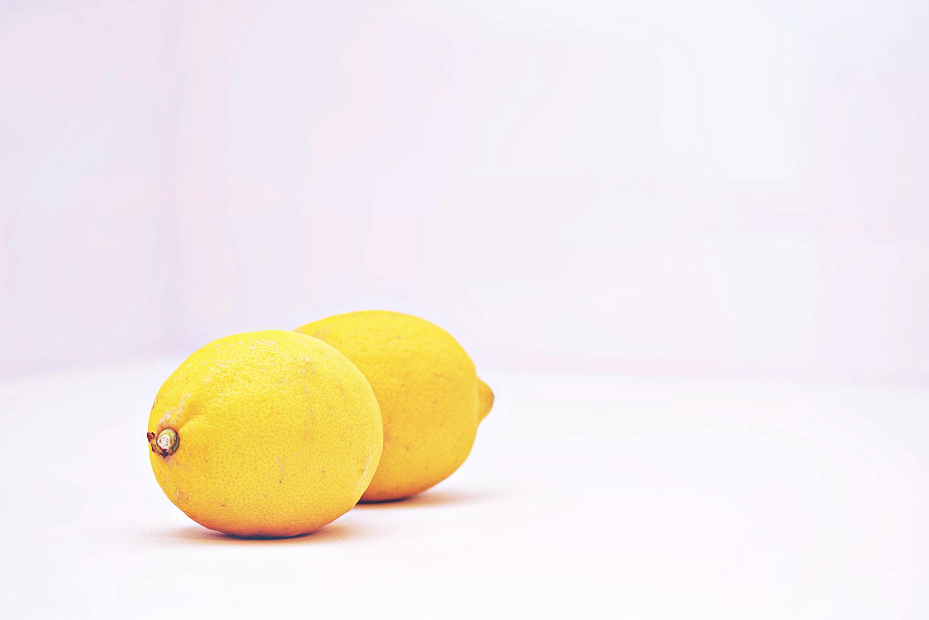 Fresh lemons on a white background representing the Lem clitoral vibrator
