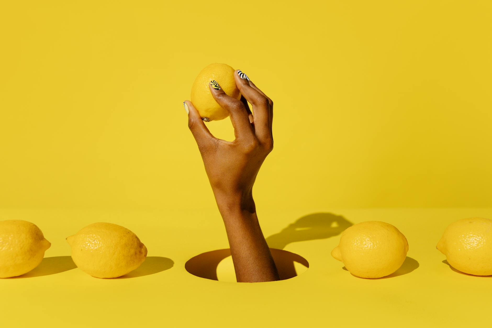A bright yellow silicone vibrator surrounded by peeled fruit on a yellow background, symbolizing pleasure and fresh sensation