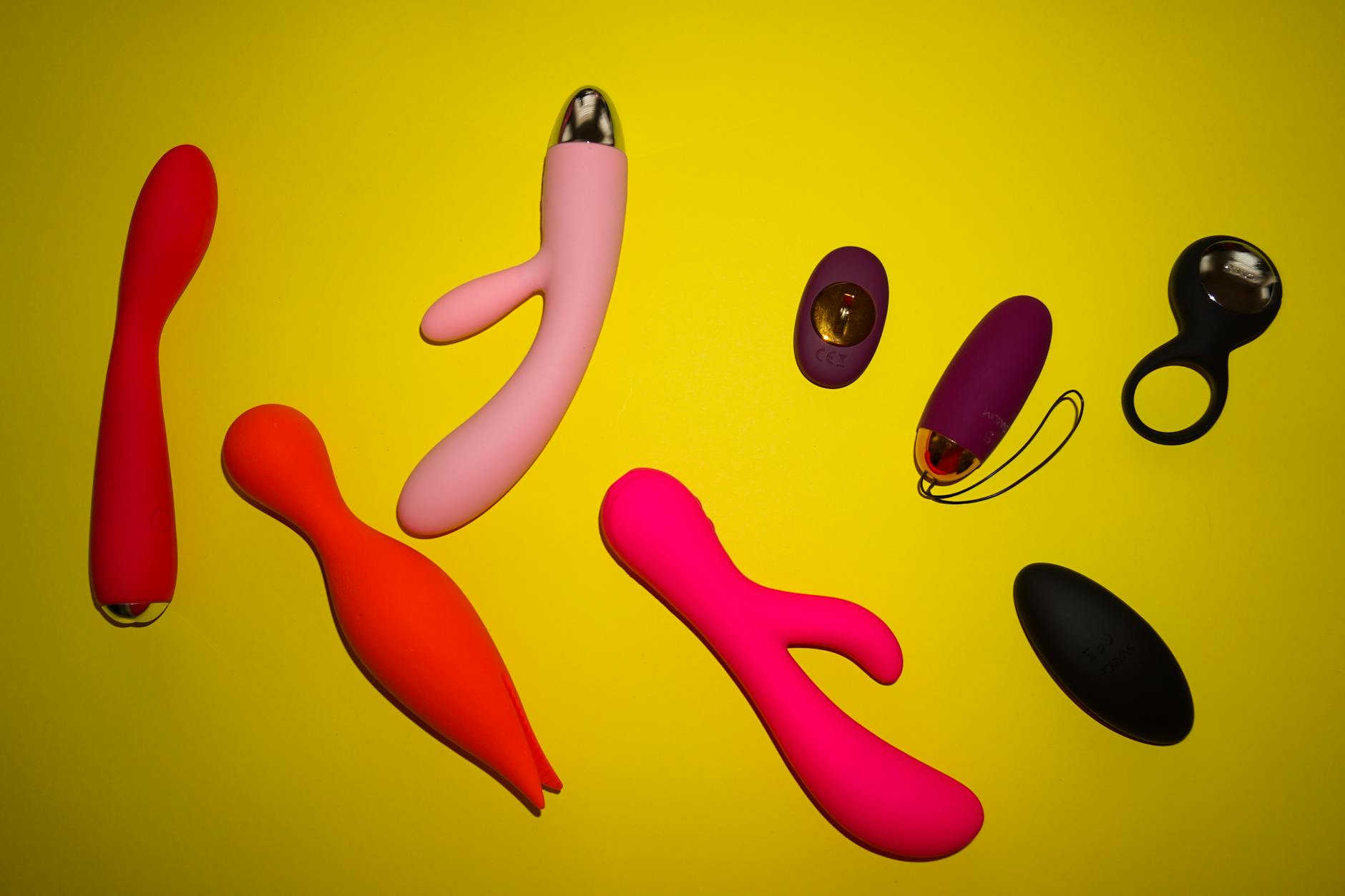 Woman holding clitoral vibrators and considering how hormonal cycles affect pleasure